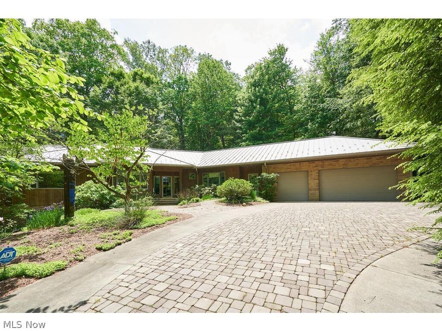 Natural oasis on nearly 2 acres with 1st floor living and panoramic views from every room! This custom-built ranch is tucked away and secluded in Merriman Woods! You’ll feel the exclusive privacy from your first drive over the paver bridge and driveway to your own escape.  Open concept 1st floor features hardwood floors milled from the oak trees located on the property prior to build (as are the int. doors), spacious living room w/ fireplace & wet bar w/ ice maker open to the dining room area w/ door to rear screened in porch, functional kitchen with maple cabinets, quartz counters, breakfast bar, and new double oven, gas range & dw (’21), master suite w/ 8x8 WIC, private study w/ built-in shelving, jacuzzi & walk-in shower, add’l ensuite bedroom with WIC, half bath, and access to master bath, office, laundry room w/ newer washer and dryer that stay, mudroom & 3 car garage w/ double doors to backyard. Take either of 2 separate stairwells down to partially finished walk-out lower level