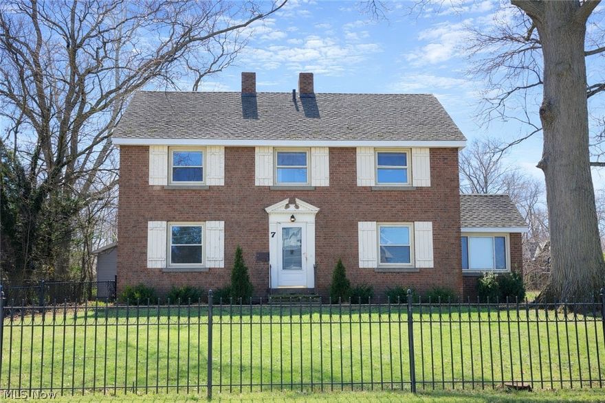 Enter into timeless character and endless potential with this classic 1931 Colonial Revival home ideally located across from Lake Erie, offering breathtaking lake views and the charm only a century home can provide. Set on three parcels totaling nearly half an acre, the property is fully enclosed with elegant wrought iron fencing and includes a three-car detached garage. The home showcases the beautiful architectural details that define historic properties such as arched windows, curved walls, crystal door knobs, hardwood floors, built-in shelving, wainscoting, and generous closet space throughout. A half bath is located off the kitchen which opens to the dining room, where a fireplace creates a warm and inviting gathering space. The living room features built-in bookshelves, classic wainscoting, another fireplace, and stunning views of Lake Erie. Just off the living room is a bonus room ideal for a home office, also overlooking the lake. Additional living space includes a former attached garage converted into a family room or rec room, offering flexibility for modern living. The second floor features five spacious bedrooms and three updated full baths, including three bedrooms with private ensuite baths. The primary suite is truly special, offering lake views and a fireplace. A convenient cedar-lined laundry closet is located on the second floor. The finished attic provides additional space. The first floor has been professionally demoed and remediated following water damage due to burst boiler pipes, leaving a blank slate ready for your custom design and renovation vision. The second floor requires only minimal repairs, allowing you to focus your creativity on transforming the main living spaces. With its prime location, incredible lake views, historic charm, and enormous potential, this property is a rare opportunity to restore and personalize a beautiful Colonial Revival home in a truly special setting. Bring your vision and make this century home shine again.