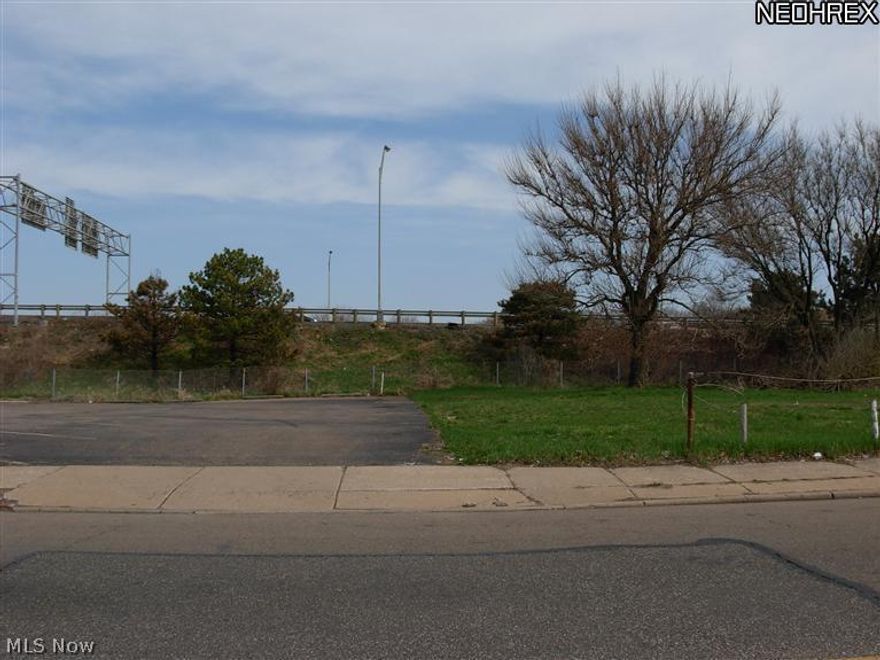 Inside lot on street with sidewalks. Surrounded by commercial lot on one side and vacant residential lot on one side.