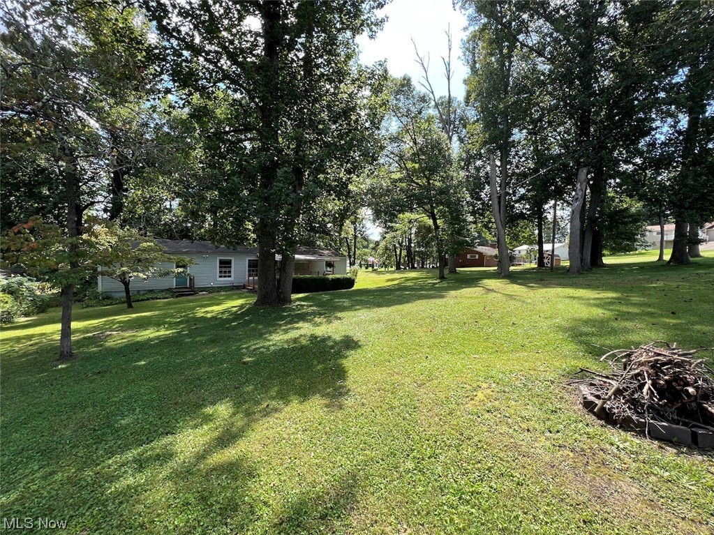 Ranch Home with Full Basement sitting on .40 Acres tucked in-between Maysville Pike & State Route 555, minutes to Downtown Zanesville, RT 60, RT 146, I70 to be in Columbus or Cambridge within 45-60 mins, while maintaining a calm neighborhood ambiance. 3 Bedrooms and 1 Bathroom on main floor features original hardwood flooring that extends throughout the majority of the residence. Upon entering, you'll find a generously sized living room and dining area seamlessly integrated with the kitchen, separated only by a tastefully updated bar countertop. All kitchen appliances, comprising a refrigerator in the kitchen and another in the garage, a stove/oven, a microwave range, a washer, and dryer, will remain with the property. The expansive unfinished basement offers versatile potential and includes washer/dryer hookups as well as a wash sink for added convenience in treating laundry or giving pets baths! The backyard outdoor space is designed for relaxing, complete with a bar area, and mounte
