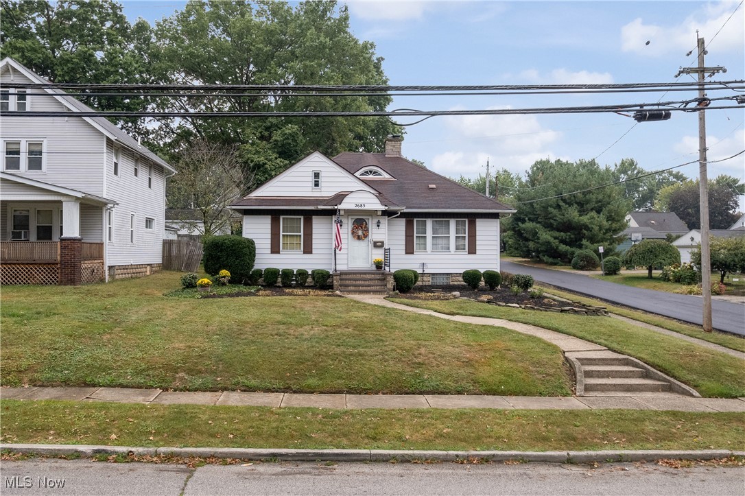 Welcome to 2685 Northland St in Cuyahoga Falls—an adorable 2-bedroom, 1.5-bath bungalow offering 1,226 sq. ft. of charm and character. This well-maintained two-owner home showcases gorgeous woodwork, arched doorways, crown molding, and high ceilings throughout. The spacious main floor includes a large primary bedroom, an updated full bath with a new shower, and hardwood floors beneath the carpet. The eat-in kitchen is a highlight with a nicely appointed pantry and an inviting breakfast nook featuring built-in bench seating and a wood plank ceiling. A gas log fireplace in the living room, cedar closets, and a laundry chute add thoughtful touches of comfort and convenience. The full basement has been waterproofed, offering excellent potential for finishing, along with a half bath and laundry area. The second floor provides even more opportunity for additional living space, making this home both move-in ready and full of possibilities. A charming enclosed porch/sunroom leads outdoors to a beautifully landscaped yard with multiple gardens. Situated on a desirable corner lot, the property also features an oversized attached 2-car garage. Recent updates include a new electrical panel (2025), offering peace of mind for years to come. Conveniently located near shopping, dining, and entertainment with easy highway access to both Akron and Cleveland, this is a home you won’t want to miss!