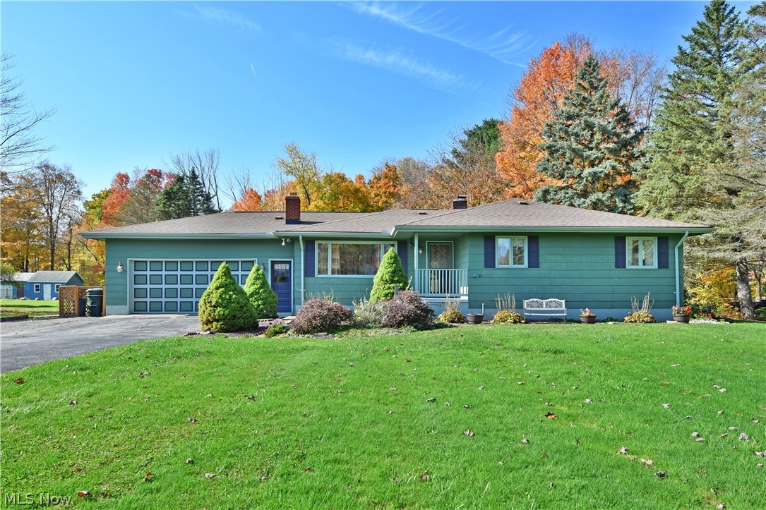Looking for more room? This beautiful rural property has it in spades! Starting with a massive yard, housing a relaxing pool with deck area and an oversized covered porch, and finishing with a four to five bedroom layout coupled with a finished basement; you’re sure to find the space for whatever you need! A long drive leads past tall trees and up to the attached two car garage. The inviting front patio brings you walking into the large sun-filled living room, trimmed with rich hardwood flooring. The spanning picture window boasts scenic views as the updated kitchen and dining area awaits through the next entryway. Natural light pours in from sliding doors to the dining area lighting the tiled flooring and the array of custom wooden cabinetry. In the kitchen, a trio of countertops pair with a stylish metal backsplash for easy meal prep and serving space. Down the main hall, four bedrooms are joined by a robust, wood-trimmed full bath. The spacious master suite offers dual closets and its own personal half bath. The three additional bedrooms are all nicely sized and offer great closet space. Downstairs, a finished family room with a wood-burning fireplace sits across from a charming kitchenette and bar area. Opposite, laundry joins additional cabinetry sat near the lower fifth bedroom with a walk-in closet. Additional features include: water softener system 2006, roof 2010, pool and deck 2015, air conditioner 2018, well pump 2019, and a one year home warranty. Call today!