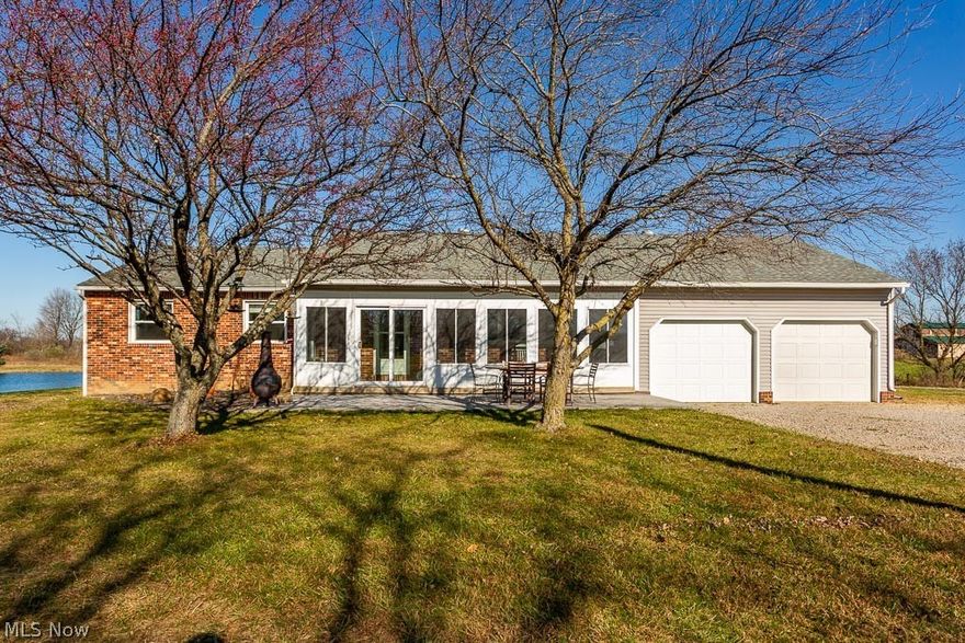 Ranch home sits on 6.9 country acres with 430 feet of frontage. A large area on east side of lot has been built up and stoned, ready for your new barn or RV parking. Nice sized 3 bedroom and 2 full baths. The baths were recently remodeled top to bottom. (Beautiful!) The front porch in enclosed with windows and screens and a stamped concrete patio just outside. Full basement is a true 'walkout' with glass block windows. Family room fireplace has a wood burning stone insert and there's a second wood burner in basement that can be run to attached garage. Updates include newer roof, gutters, siding, garage doors and windows (all except 1). Large split ownership stocked pond features a beach, shade trees, electricity. Great place for summer fun. Property includes wood with plenty of wildlife.