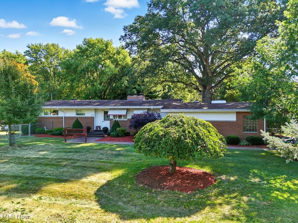 Welcome to 8630 Schubert Ave NE, a spacious 4-bedroom brick ranch set on nearly an acre of serene land in Alliance. This thoughtfully cared-for home offers a seamless blend of comfort, functionality, and natural beauty. The inviting living room features a cozy wood-burning fireplace and expansive windows that frame stunning views of the nature-lover’s backyard. The kitchen provides ample cabinet space and comes complete with 2023 appliances, while the bathroom includes a relaxing jacuzzi tub. Three generously sized bedrooms complete the main level. The walk-out basement expands the living space with a massive family room featuring a gas log fireplace, a recently finished full kitchen, a full bath, an additional bedroom, and a laundry room—perfect for extended living or entertaining. An attached 2-car garage and a charming enclosed back porch add to the home’s convenience. A second detached garage offers even more versatility with a dedicated workshop, abundant attic storage, and a wood-burning stove. Outdoors, the property is a haven for wildlife, with deer, wild turkey, and a variety of birds frequenting the yard. A remarkable 200+ year-old Silver Oak anchors the backyard, adding both history and grandeur. Behind the detached garage lies an asparagus garden, while the front yard offers a fenced-in area, along with a separate fenced garden. The well and septic have been meticulously maintained and furnace is 2023, ensuring peace of mind. This property is the perfect blend of serene country living, practical workshop space, and a welcoming home environment so conveniently close to shopping—all ready for its next chapter.