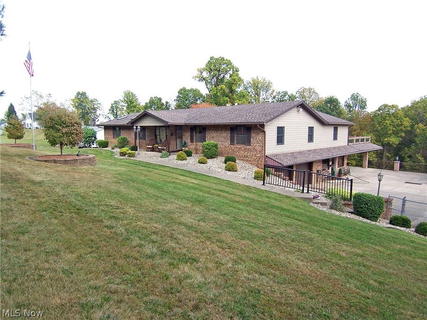 Serene country living in this one floor brick & concrete board home. Beautiful hardwoods throughout. Updated eat-in kitchen with granite countertops and hickory cabinetry and doors to large composite deck overlooking rolling back yard and woods. Main level boasts large great room with cultured stone fireplace and double doors to 24x21 sunroom and access to deck as well. Large master suite includes sitting area with laundry room just off the bath and yet another door to deck. Basement has 4th bedroom, half bath (room for shower), 21x19 workshop, large rec room, 2 storage rooms and access to garage and current office space with separate door to outside. Would be great for home business. Additional land with rental and/or business/ware house. Whole house generator, alarm system, tankless water heater just to name a few amenities.