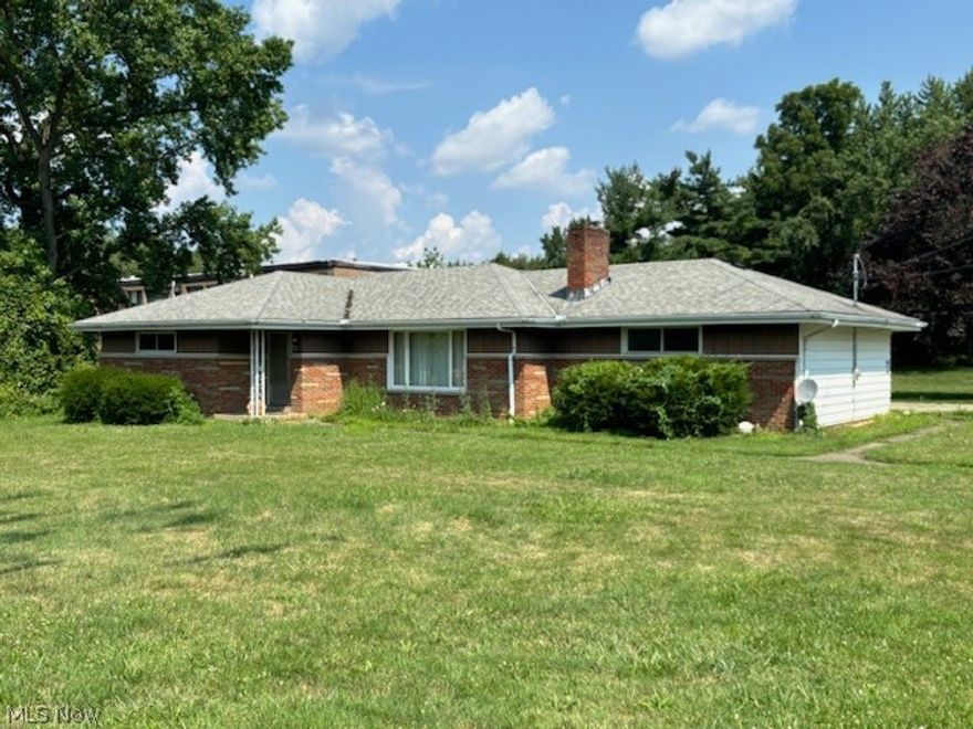 Spacious brick and Aluminum ranch situated on 1.56 acres near expressways and tons of shopping and restaurants.  The large living room has a big picture window and Stone fireplace (see disclosure).  There is a formal dining room and oversized kitchen with wood cabinets.  All three bedrooms have hardwood floors.  There is a nice size back yard, a 2 car attached and 2 car detached garage and the back of the lot is heavily wooded.  Waterloo Rd. has multiple properties with various zoning, this home could be a primary residence or possible business.