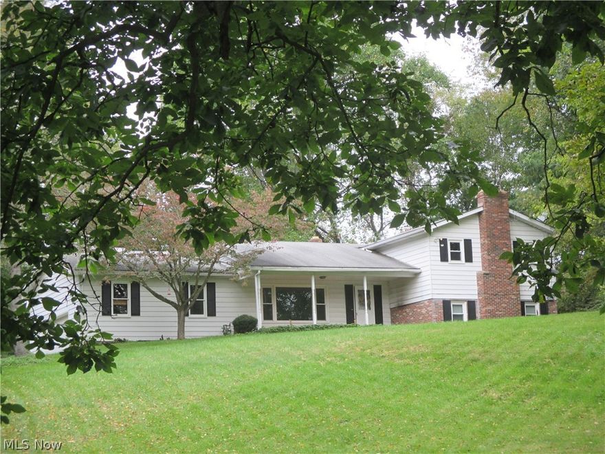 You will fall in love with this beautiful country setting, high on a hill on a 3 acre parcel only minutes to the conveniences of Akron and Medina.  The kitchen has loads of cabinets plus an eating area.  There are loads of closets and storage throughout the home.  The family room has a full wall of beautiful custom cherry bookshelves and storage plus a double closet.  It is currently used as a combination office, family room and library.   A 24' X 60' two story storage building quality built 16 on center construction.  There is parking for 2 vehicles.  It is heated and insulated with 3/4 plywood floor for comfort while working on projects.  There is 100 amp electrical service and a loft that 16' wide, 34' long and 7' high work area, plus storage areas.  Great for a serious "man cave' or a home based business. This is a well built home on a wonderful parcel of land waiting for your occupancy. Two Parcels, one 2 acres and one 1 acre. NEW CARPET installed throughout by Nov 10th.