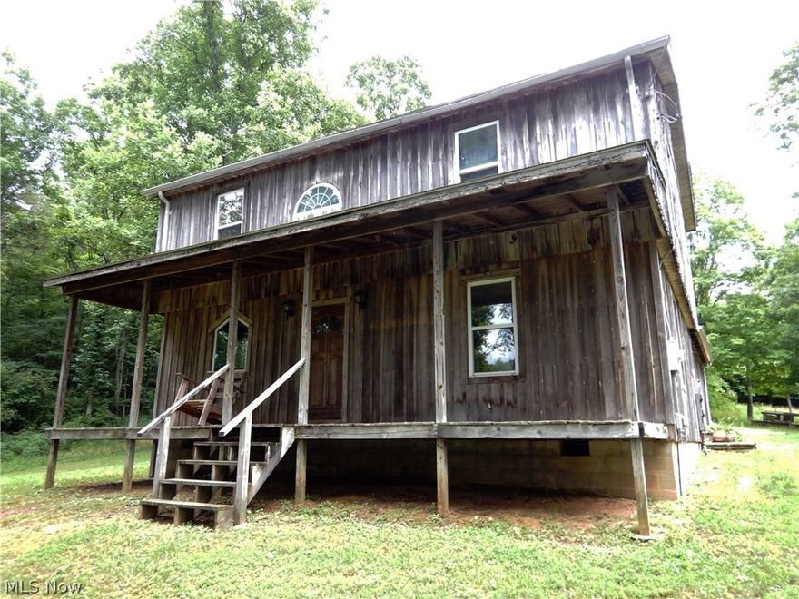 GPS Coordinates: 39.312434, -81.041468 . Rustic Beauty with a Modern Flair is the best way to describe this lovingly crafted home perched atop a hill! If you are looking for a serene country setting with panoramic views and plenty of privacy, this home is for you! Access your very private home by crossing through a small creek, passing your ONE neighbor, and driving up the public (unmarked) road to your driveway on the left. You can enjoy many beautiful evenings relaxing on either your 32' x 07' Front OR 24' x 08' Side Porch and take in the beauty of nature! Inside you will find a very modern house waiting for you to add your own personal touches to it! The open floorplan concept lends itself to entertaining family and friends both indoors and out. The Kitchen boasts modern cabinetry and a Breakfast Bar with the Dining Area adjacent for easily serving meals. The spacious Living Room will become the focal point for family gatherings. You can relax at the end of the day in your tranquil