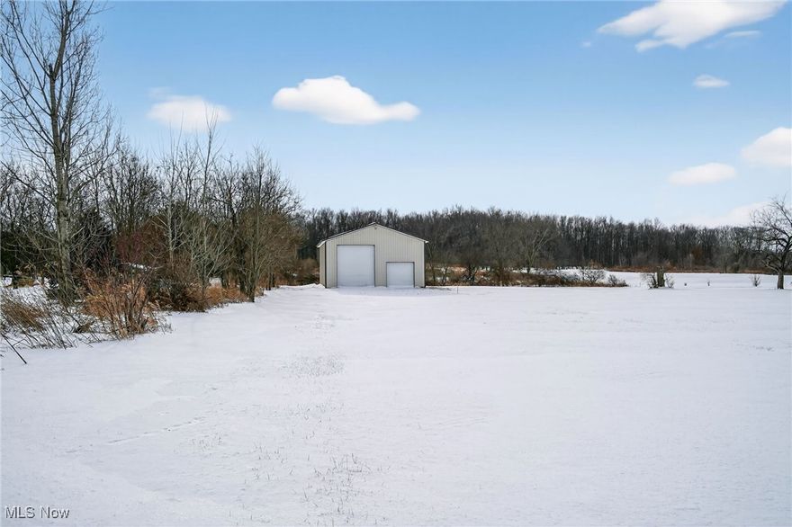 Rare opportunity on a 5+ acre building lot with an exceptional pole building already in place. This mostly flat to gently sloping parcel features a solid 32' x 44' metal structure with a reinforced concrete floor, 14' high door, insulated doors and roof, and electric service already in the building. Public water is on the property with a new water line and paid water tap installed as of 12/23, and the building is plumbed for a future half bath. A driveway is already in, and the property offers privacy with woods in the back and a seasonal creek that flows behind the pole building across the lot. Ideal for a future home site or hobby farm.  Don't miss this versatile property with major improvements already completed!  Around the corner attractions include: Hurdle Waterfowl Park and Sprinkle’s Serenity Park.