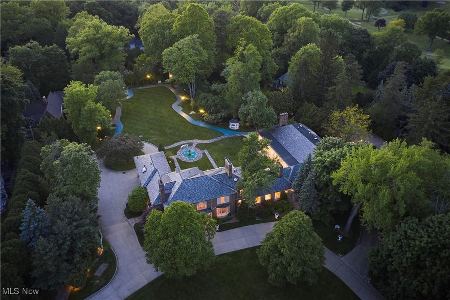 Discover timeless sophistication and the essence of West Akron gracious living at this extraordinary Fairlawn Heights estate, which was designed in 1930 by noted architect Maxwell Norcross and expanded by the owner of Hamlin Construction as his residence in the 1980s and 2010s.  48 South Wheaton Rd offers 10,525 square feet of refined living on 3.1 impeccably maintained acres—blending resort-style luxury with urban convenience.  Gracious gathering spaces include a stately library, formal dining room, charming kitchen, and elegant living room, plus a magnificent great room with private entrance. A luminous sunroom and dramatic 60-foot colonnade overlook the serene grounds, while finished lower-level recreation rooms add versatility. The home features 8 bedrooms and 8.4 baths, including two fully appointed guest/staff apartments. Two luxurious first-floor bedroom suites offer 12-foot ceilings, fireplaces, spa-style baths, and expansive closets.  Every detail—from lighting to millwork—respects the home’s architectural legacy. Outside, over three acres of landscaped gardens form a private, park-like retreat with fountain, pathways, mature trees, and dramatic lighting. Dual-level garages with numerous parking options even include space for a limousine! A rare opportunity for elevated living just minutes from Akron and within easy reach of Cleveland, Lake Erie, and Cuyahoga Valley National Park.