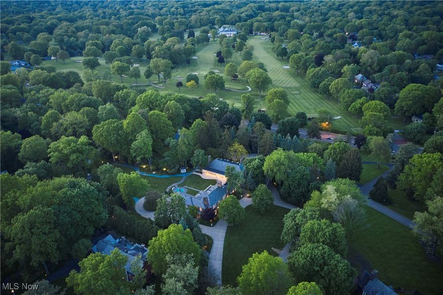 Discover timeless sophistication and the essence of West Akron gracious living at this extraordinary Fairlawn Heights estate, which was designed in 1930 by noted architect Maxwell Norcross and expanded by the owner of Hamlin Construction as his residence in the 1980s and 2010s.  48 South Wheaton Rd offers 10,525 square feet of refined living on 3.1 impeccably maintained acres—blending resort-style luxury with urban convenience.  Gracious gathering spaces include a stately library, formal dining room, charming kitchen, and elegant living room, plus a magnificent great room with private entrance. A luminous sunroom and dramatic 60-foot colonnade overlook the serene grounds, while finished lower-level recreation rooms add versatility. The home features 8 bedrooms and 8.4 baths, including two fully appointed guest/staff apartments. Two luxurious first-floor bedroom suites offer 12-foot ceilings, fireplaces, spa-style baths, and expansive closets.  Every detail—from lighting to millwork—respects the home’s architectural legacy. Outside, over three acres of landscaped gardens form a private, park-like retreat with fountain, pathways, mature trees, and dramatic lighting. Dual-level garages with numerous parking options even include space for a limousine! A rare opportunity for elevated living just minutes from Akron and within easy reach of Cleveland, Lake Erie, and Cuyahoga Valley National Park.