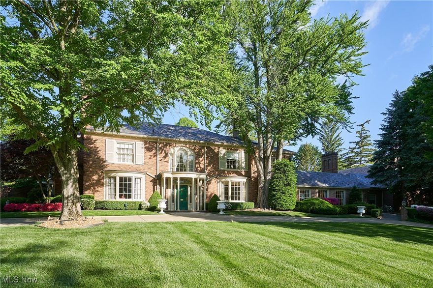 Discover timeless sophistication and the essence of West Akron gracious living at this extraordinary Fairlawn Heights estate, which was designed in 1930 by noted architect Maxwell Norcross and expanded by the owner of Hamlin Construction as his residence in the 1980s and 2010s.  48 South Wheaton Rd offers 10,525 square feet of refined living on 3.1 impeccably maintained acres—blending resort-style luxury with urban convenience.  Gracious gathering spaces include a stately library, formal dining room, charming kitchen, and elegant living room, plus a magnificent great room with private entrance. A luminous sunroom and dramatic 60-foot colonnade overlook the serene grounds, while finished lower-level recreation rooms add versatility. The home features 8 bedrooms and 8.4 baths, including two fully appointed guest/staff apartments. Two luxurious first-floor bedroom suites offer 12-foot ceilings, fireplaces, spa-style baths, and expansive closets.  Every detail—from lighting to millwork—respects the home’s architectural legacy. Outside, over three acres of landscaped gardens form a private, park-like retreat with fountain, pathways, mature trees, and dramatic lighting. Dual-level garages with numerous parking options even include space for a limousine! A rare opportunity for elevated living just minutes from Akron and within easy reach of Cleveland, Lake Erie, and Cuyahoga Valley National Park.