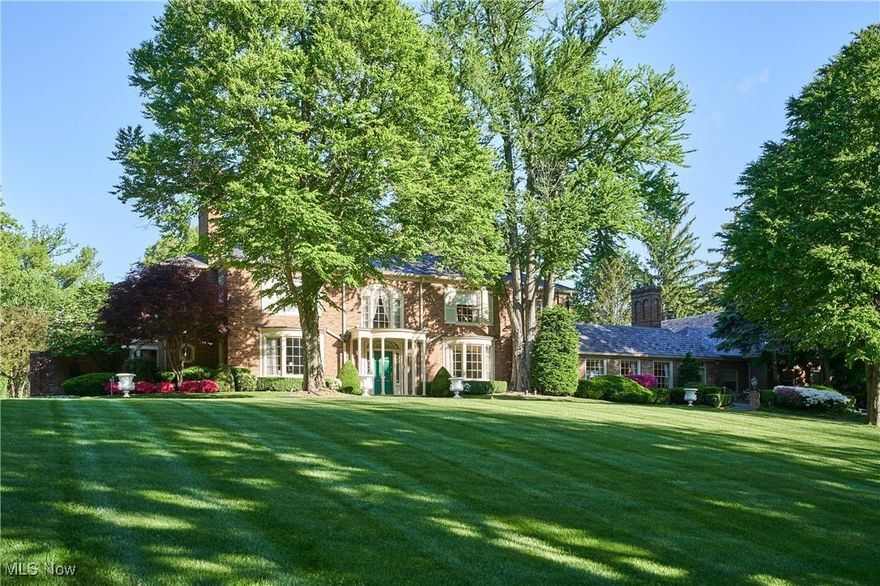 Discover timeless sophistication and the essence of West Akron gracious living at this extraordinary Fairlawn Heights estate, which was designed in 1930 by noted architect Maxwell Norcross and expanded by the owner of Hamlin Construction as his residence in the 1980s and 2010s.  48 South Wheaton Rd offers 10,525 square feet of refined living on 3.1 impeccably maintained acres—blending resort-style luxury with urban convenience.  Gracious gathering spaces include a stately library, formal dining room, charming kitchen, and elegant living room, plus a magnificent great room with private entrance. A luminous sunroom and dramatic 60-foot colonnade overlook the serene grounds, while finished lower-level recreation rooms add versatility. The home features 8 bedrooms and 8.4 baths, including two fully appointed guest/staff apartments. Two luxurious first-floor bedroom suites offer 12-foot ceilings, fireplaces, spa-style baths, and expansive closets.  Every detail—from lighting to millwork—respects the home’s architectural legacy. Outside, over three acres of landscaped gardens form a private, park-like retreat with fountain, pathways, mature trees, and dramatic lighting. Dual-level garages with numerous parking options even include space for a limousine! A rare opportunity for elevated living just minutes from Akron and within easy reach of Cleveland, Lake Erie, and Cuyahoga Valley National Park.