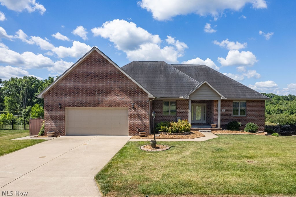 Introducing 51 Harper drive in the coveted Westwood subdivision! This gorgeous home is less than 20 years old and features so many amenities! One level living, open concept, gleaming hardwood floors, 9' ceilings, smart security system, and so much more! Located just inside Westwood, you'll be impressed upon arrival at the stately curb appeal and welcoming front porch. With all sides of the home bricked, there's no worries with durability or maintenance. Inside, the foyer opens into the dining and living rooms, with a gas log fireplace flanked by doors on either side to the deck. On the right wing of the home, a luxurious primary suite awaits. With double vanities, a HUGE 4'x8' dual shower with customizable lighting and bluetooth sound, and an expansive closet custom fitted with shelving and racks, it will quite possibly be your favorite area of the home! The kitchen- appointed with maple Kraft-Maid cabinetry- features a large island, tile backsplash, and room for another dining area. On the left wing of the home are two more bedrooms, a full bath, and laundry room with access to the oversized garage. Downstairs, a massive 27x31 rec room includes space for relaxing and entertaining, with a large wet bar, full bath, and walkout access to the lower patio (with hookup for a hot tub) and large back yard. The downstairs level also includes a fourth bedroom, unfinished utility/storage area, and a bonus space great for a hobby room, man cave, or workshop. The large back yard and deck offer plenty of outdoor space to enjoy. This rare opportunity to live a one-level lifestyle in Westwood doesn't come along often. Available for immediate occupancy, schedule a showing to see just how easily you can move in and enjoy all the amenities this home has to offer.