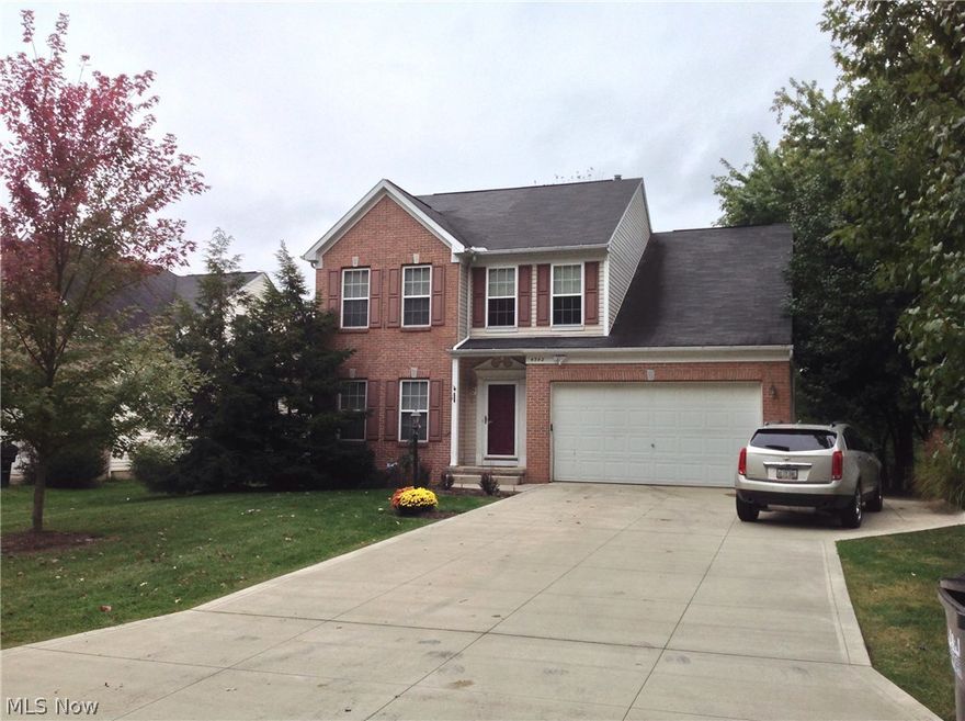 Stunning brick and vinyl colonial formal model, with lots of extras. Wood floors in foyer and threw the kitchen. Dramatic pillar entry, niche, open floor plan. Great room has newer carpeting and gas fireplace. Kitchen has a newer island with loads of cabinets open to great room and dining room. patio doors to a spectacular 3 tier deck, hot tub, bar area with 8 stools and a concrete counter under a pergola. Upstairs has 4 bedrooms. master has vaulted ceiling, glamour bath and a walk in closet. The finished basement has a remote control gas fireplace with heat blower, wet bar with beverage fridge, dart board and is wired for surround sound. There is an office or 5th bedroom which has wainscoting, built ins and carpeted. Other room is an exercise room there is washer and dryer hookups, and a wall mounted tv which stays. There is also a first floor laundry room which includes the washer and dryer. Newer large driveway with an extra side pad for a boat or trailer.High Efficiency Furnace 4 y