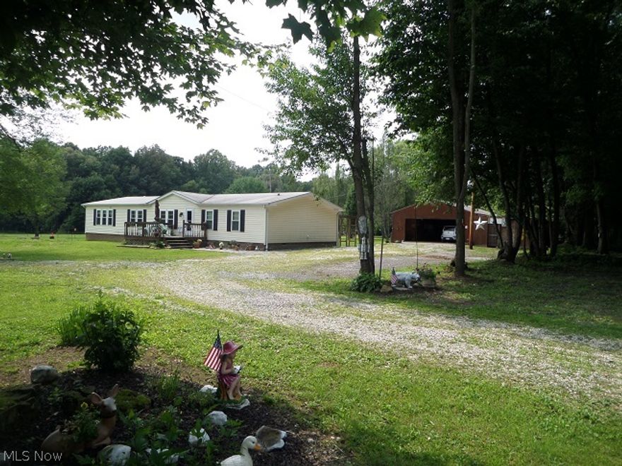 This wonderful  ranch style home is located on a rural side street with privacy. Many updates within the last year include newer carpet in all three bedrooms, Allure flooring in the kitchen, mud room and all 3 baths, tank less hot water heater, water softener, wood laminate flooring in the dining, living and family rm, 200 amp breaker box, ceiling fans, all rooms have been painted, custom entry doors by Lawson and septic has been updated and pumped. Fantastic 20x40  four car garage with a lean-to which is currently a horse stall/run in. Snuggled in the woods is a shed/chicken coop with some fencing. Huge kitchen has an eat-in area, abundant cabinet & counter space, center island/bar and beautiful views out the windows! Wonderful open floor plan with very spacious rooms! Owners put the washer & dryer in the master bath where the tub was but is still plumbed in case new owner wants to add a tub. Mud room still has hook up for washer & dryer.  Adorab;e rustic half bath. Front & rear decks