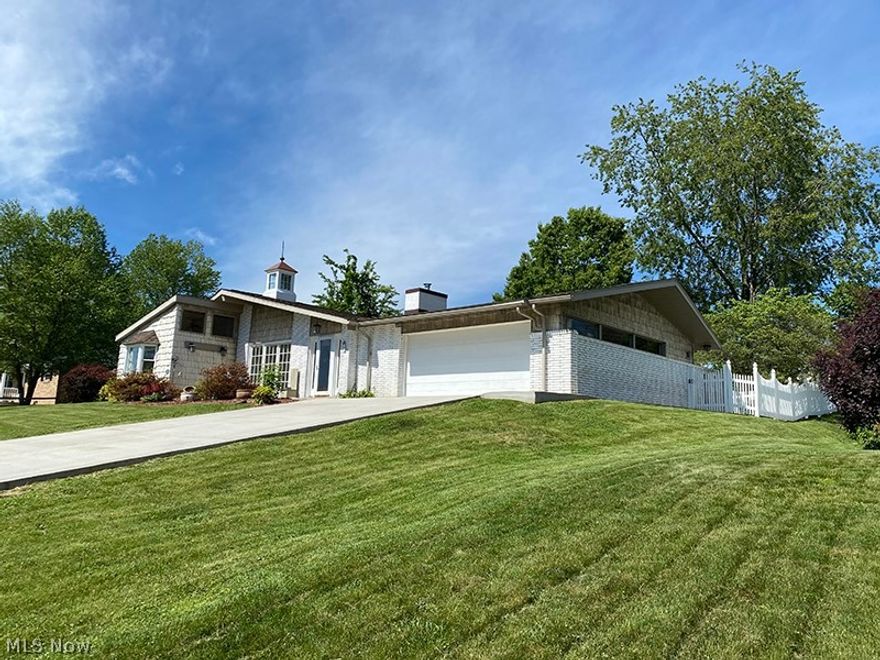 This home is a true delight inside and out featuring 2187 square feet of light filled living space and situated on approximately 1/3 acre. The features are many starting with inlaid imported marble floors, stile & rail 6 panel quarter sawn red oak doors, red & white oak wood trim throughout, freshly painted interior, new carpet in Living Room, Master suite, 3rd bedroom and hall. Many large Anderson windows. New Amish installed concrete driveway and roof. Updated kitchen appliances and custom hickory kitchen cabinets. Real stone and marble floors in kitchen, dining, laundry, foyer and mudroom. Extensive interior masonry. The outdoor space includes a completely enclosed back yard with white picket fence, a large custom built storage building with mezzanine on a concrete foundation, and a large back patio area. Public water will be connected prior to closing.
