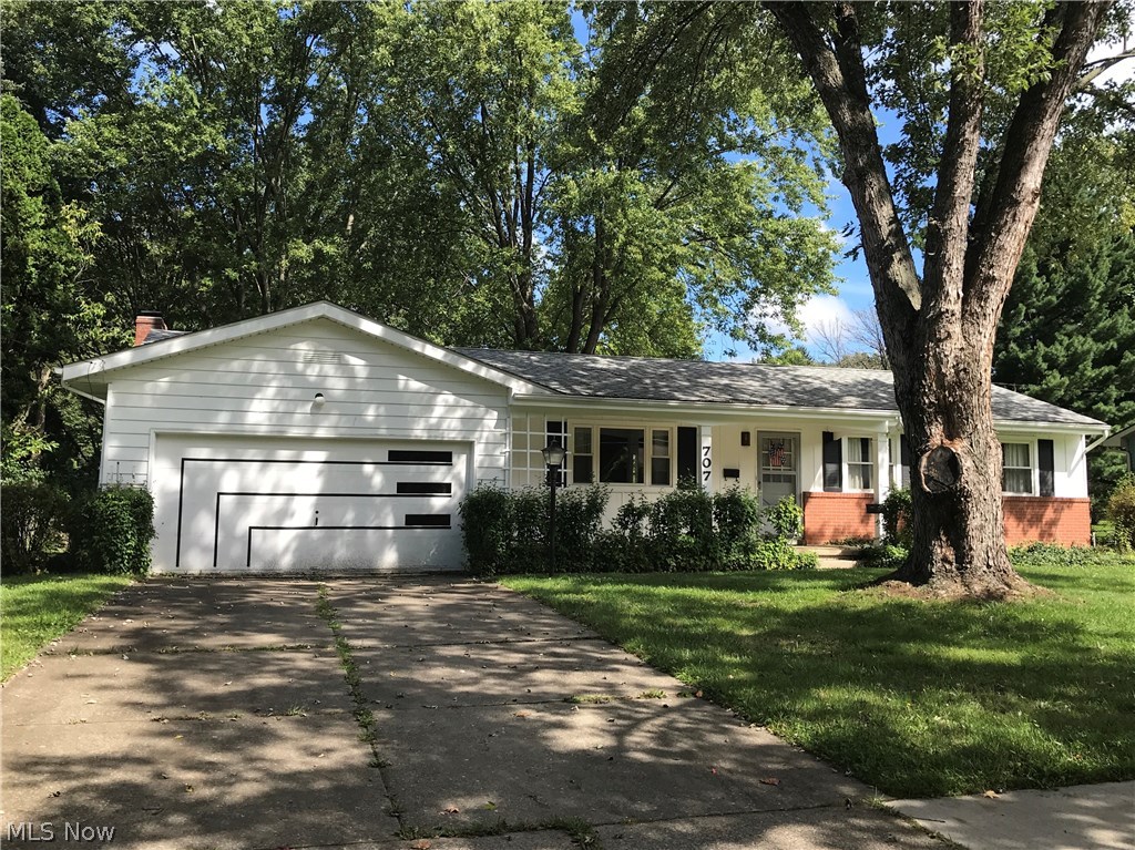 Situated adjacent to Chadwick Neighborhood Park w/ entrance gate from its fully fenced back yard, 707 Ivan Drive in Kent, Ohio is awaiting your HGTV sensibilities. Best described as "Dated but WELL-CARED-FOR" it boasts untouched original hardwood under original carpet in 3 bedrooms, hallway, dining and spacious front living room, allowing you to bring much life back to this property simply by removing the carpeting! With newer roof, vinyl replacement windows throughout and lower maintenance aluminum exterior, it's easy to move into! Lower level Rec Room adds an additional 750 Sq. Ft. of living space beyond tax record. Furnace serviced annually in fall. Owners have installed new dishwasher (Aug. 2018), replaced most plumbing fixtures, cleaned gutters and had the house professionally cleaned & power washed all in preparation for your purchase. Neutral colors in most of home, including tile in both baths and kitchen. Also Newer: roof (2011), Range & Disposal (2011) and Dryer (2016). Washi