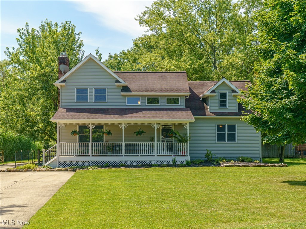 Welcome to 1165 Royalwood Rd in Broadview Heights, located within walking distance to parks and community baseball fields.
Nestled on a picturesque, wooded lot of nearly an acre, this charming colonial is located in the highly sought-after Brecksville-Broadview Heights School District. Offering a perfect blend of traditional comforts and modern updates, this well-maintained 3-bedroom, 3-full-bath home spans 2,445 sq ft. Upon entering from the large covered front porch, you are greeted by a grand white staircase leading to a spacious living room. This inviting communal space features a cozy wood-burning fireplace, LVT flooring, a ceiling fan, and ample windows that provide scenic views of the surrounding nature all year round. The eat-in kitchen is a chef’s dream, featuring hardwood floors, Schrock cabinets, new SS appliances, an oversized sink, and beautiful countertops. The slider off the kitchen leads to a covered rear porch. The main floor also includes a formal dining room and foyer with hardwood floors, ample closets, a tiled mudroom and full bath. Upstairs, a large open family room offers endless versatility, ideal for use as a home office, playroom, or media space. The private master suite offers vaulted ceilings, ceiling fan, LVT flooring, a walk-in closet, and an en-suite bath with a separate water closet. Two additional bedrooms share a full bath, with one bedroom featuring a walk-in closet and a private covered porch. Laundry becomes a breeze in the large 2nd floor laundry room. The partially finished basement offers versatility with space for a home office, rec rm or gym complimented with cozy gas fireplace. The basement also includes a large workshop. The attached two-car garage has access into the mudroom and basement. Step outside to enjoy the serenity and privacy of mature trees, a fully fenced-in yard and a large storage shed, This home offers a perfect balance of privacy and convenience, situated near local amenities and I-77 for an easy commute.