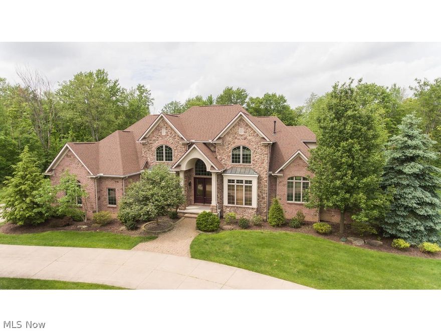 Gorgeous stone/brick colonial w/ 10ft 1st floor ceilings, 6700+ sq ft of living space, 4 bedrooms, 5.5 baths on 2.09 acres in Richfield Township. Two story foyer flanked by library w/ gas fireplace & formal dining room w/ butler's pantry. Walk in the front door & see through to the towering two story great room w/ floor to ceiling windows and gas fireplace. Chef's kitchen includes Diamond maple cabinetry in "Coconut finish w/ toasted almond glaze", granite countertops, center island, "sunset bronze" appliances, frosted glass backsplash & walk-in pantry w/ custom shelving. Kitchen bar top open to hearth room w/ gas fireplace, dry bar, walls of windows. First floor master bedroom w/ vaulted ceiling. Expansive master bath with h/h sinks, granite countertops, jetted tub, double ceramic shower and flooring & dual entry master closet w/ Tailored Living custom shelving. Dual staircases lead to the second level w/ 3 spacious bedrooms, all w/ ensuite baths, granite & linen & walk-in closets w/