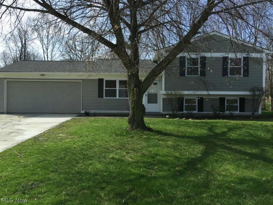 UPDATES ADDED - This gorgeous Split is priced THOUSANDS below neighborhood values for a quick sale and instant equity.  The home is located on almost 1/2 an acre and the backyard is completely fenced in.  The home features a new roof, new furnace, new A/C, new windows, new flooring, new lighting, new bathrooms, new garage opener, a newly surfaced driveway and an updated kitchen with appliances.  The large 2 car garage also has a rear door that leads to the large fenced in back yard.  The 3 bedrooms all have new carpeting and walk in closets.  The home features an eat in kitchen and a very large laundry room which can be set up for added storage or an office.  There is plenty of storage in this home.  On top of all of the major updates already being done, this home features a FREE 1 year Home Warranty.  All you need to do is bring your furniture.  What more could you ask for?  Call today and set up a showing - this home WILL NOT LAST AT THIS PRICE!