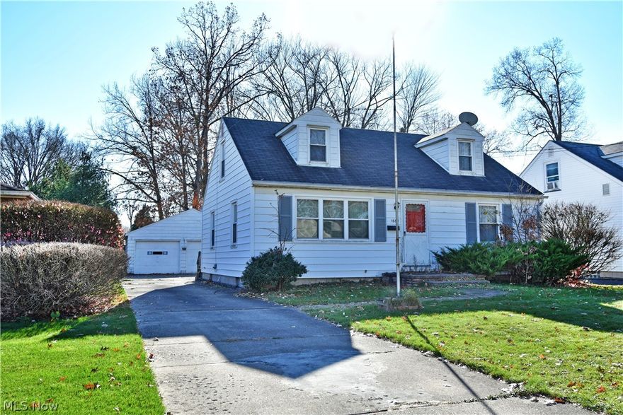 Perfectly cozy and packed with potential, this four-bedroom Warren home may have just what it takes for you! A charming cape cod layout with a detached two-car garage boasts a sizeable yard as a bold, red front door makes for a great accent color. Inside the front door, a welcoming living room greets with an expansive picture window that lets sunlight into the hardwood floors below. Nearby, the substantial kitchen and dining areas fill the rearmost of the home with a wrapping chair rail and natural woodwork that pairs with the opposing cabinetry. Retro flavored pink tile work joins the long-running laminate counters and flooring to complete the package. A short hall leads past a full first-floor bath where matching tile continues along with a quaint vanity. The two first floor bedrooms offer carpeted flooring and personal closet space alike. Upstairs, a pair of dormer style bedrooms showcase elegant hardwoods and plenty of living space. Below, a full basement is home to a potential of