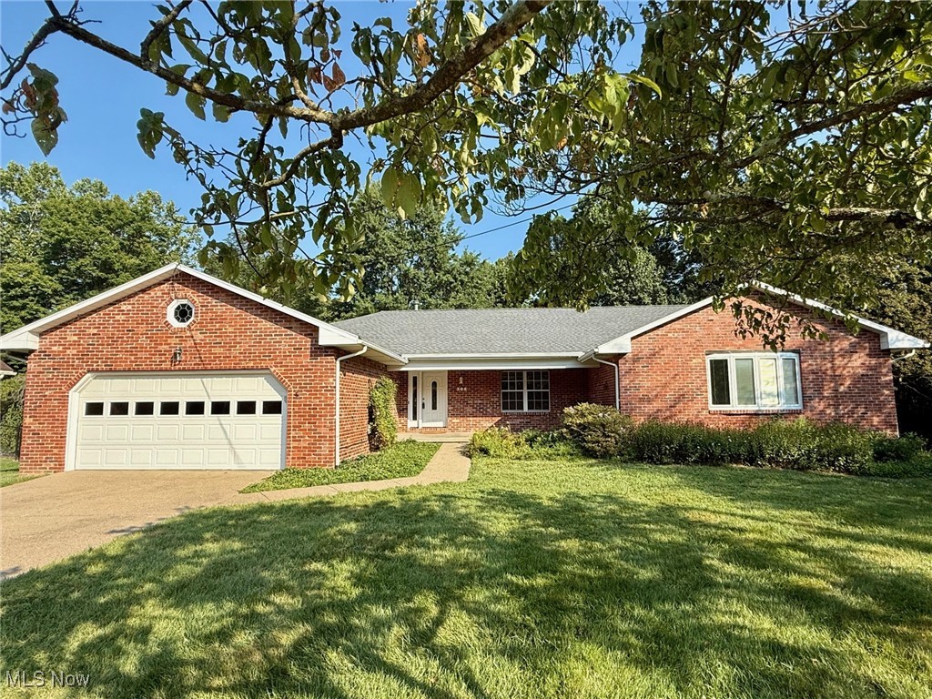 BRAND NEW ROOF! Check it out!! Welcome home to this immaculate 4 bedroom, 2-1/2 bath brick ranch home nestled in one of the area's most desirable subdivisions. Tucked away at the end of a peaceful cul-de-sac and backing up to serene woods, this home offers the perfect blend of privacy, comfort and convenience - just minutes from downtown, yet with that country feel. Step inside and you'll be greeted by a slate entry and new hardwood flooring in the living room and dining room. The heart of the home is the spacious kitchen with raised panel hickory cabinets, a pantry, built-in desk area, coffee bar space and a large window for ample light. The kitchen/dinette opens to the beautiful family room with its vaulted ceiling, brick fireplace flanked by custom cabinetry, and large windows overlooking the woods. Step outside and relax on the brand new rear or enjoy your morning coffee on the charming covered front porch. The massive primary bedroom features a huge walk-in closet and an updated bath with heated tile floor and a double bowl sink. The other 3 large bedrooms share the main full bath. A first floor laundry room and a 1/2 bath add convenience and the basement offers ample room for storage, a home gym or workshop space. The whole house generator provides peace of mind for the homeowner. This maintenance free, all brick home is much larger than it appears - a true must-see!