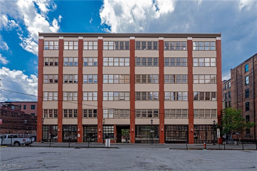 Welcome to Erie Building #604—a one-of-a-kind, industrial loft with a private rooftop terrace and a front-row seat to downtown living. Thoughtfully upgraded and artfully designed, this residence blends Manhattan-style edge with elevated, modern comfort.
Inside, 1,800 square feet of open-concept living unfolds with soaring ceilings, exposed brick, rich dark wood floors, and skyline views through a dramatic wall of windows. A sleek two-way fireplace anchors the living and dining spaces, all freshly repainted in 2020 (main level) and 2025 (upper level). Overhead, statement light fixtures—custom in the living room (2018) and newly updated in the kitchen (2025)—add sculptural interest.
The kitchen is a chef’s dream, with polished concrete countertops, ample cabinetry, and updated appliances. The primary suite offers a serene escape with a custom walk-in closet, Rainforest shower, and recent upgrades including modern sink faucets and a new mirror.
A spiral staircase leads to a flexible loft space and your private rooftop deck—newly expanded and upgraded in 2023 with Trex decking and integrated lighting. It’s the ultimate outdoor lounge for entertaining, relaxing, or city gardening, all with unobstructed views of the sunset. 
Additional updates include new HVAC in 2023, a new washer/dryer in 2021, and a deeded parking spot for added convenience. Enjoy the benefits of unbeatable access to everything downtown has to offer—from renowned restaurants and nightlife to sports venues, the theatre district, the casino, and more.