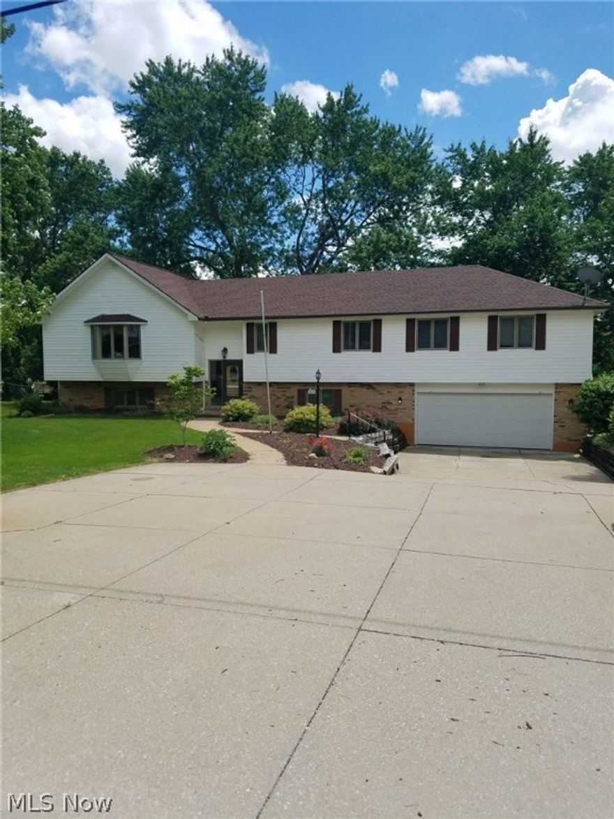 Beautiful Bi-level home in the heart of Brunswick. From the moment you pull into the driveway you can see this home has been lovingly maintained. The main level has an open floor layout. The family room and dining room feature vaulted ceilings and beautiful wood trim. The large kitchen has gorgeous oak cabinetry, plenty of counter space, updated tiled backsplash and appliances stay. The master bedroom has ample closet space and a door that leads out to the large deck where you can enjoy the peaceful summer evenings, the deck runs the full length of the home and can also be accessed from the kitchen. There are two full bathrooms on the main level, one of which has a walk in shower. Three other great sized bedrooms complete the main level. The lower level could be used as an in-law or teen suite. The lower level features its own kitchen with brand new tiled flooring, appliances stay. Also in the lower level is a large family room that features new carpet, plenty of light and wood burning