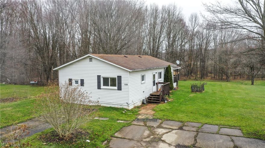 If you’ve been dreaming of country living at an affordable price, this may be the opportunity you’ve been waiting for. This 2-bedroom, 1.5 bathroom manufactured home offers approximately 1,200 square feet and sits on over 2 peaceful acres in the James A. Garfield School District — a rare chance to own land and privacy in a highly desirable area.
Several important updates have already been completed, including central air (2022), hot water tank (2022),new water softener (2021), New windows ,(2021), New Fence (2025) new supply lines (2026), and newer insulation underneath the home, giving peace of mind on major mechanical items.
Step outside onto the large back deck and enjoy the quiet views of woods and nature all around you. The property also includes outbuildings and a well house, providing extra storage and functionality.
This property is being sold as-is, and the seller will make no repairs. The home may need updates and some work, but it is 
currently occupied and offers a great opportunity for someone looking to build equity, invest, or simply enjoy country living with space and privacy.
Seller will review offers on Monday March 30th at 1:00 PM. No offers will be accepted prior. There is no need to rush weekend showings; buyers and agents are encouraged to take their time.   We are having an open house Sunday 2-4pm.
Affordable homes on acreage in this area don’t come up often — schedule your showing and come see the potential for yourself.