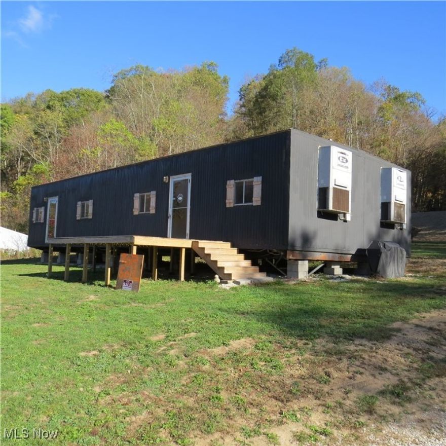 Approx 1990 2-section 24'x56' manufactured office trailer to be moved by buyer. Owners were going to convert to living quarters but have changed their minds. The floor plan included 4 separate office rooms, 2 restrooms, and an entry room. Owners removed 1 wall which could easily be replaced. The interior is paneled or has dry wall. There are no kitchen nor closets. The structure is total electric with 2 self-contained heating and cooling units. Also included are the tongues, block, bracing, and tie-downs. The wooden deck is not included. This is an untitled structure. NO REAL ESTATE INCLUDED. This would make a residence, hunting lodge / cabin for your deer camp, workshop, or an office bldg. Call with questions or to schedule a showing.