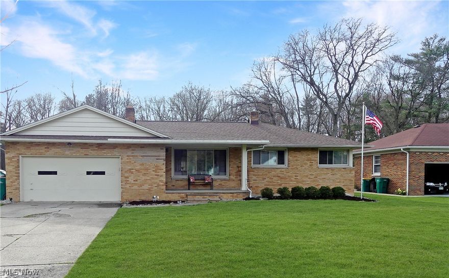 TRANQUIL RANCH LIVING! Imagine yourself having a cup of coffee while overlooking your parklike back yard in the mornings! Come discover serenity in this 3BR, 1.5BA brick ranch set on a .94-acre parklike lot. Beautiful wood floors lead you through a spacious layout, including an eat-in kitchen with potential for a first-floor laundry. Enjoy outdoor gatherings on the covered porch and brick patio. Also included is a spacious basement with nature stone flooring and a rec room with a 2nd fireplace. 2024 updates include new bathtub in main bathroom, garbage disposal and hot water tank.  Updates in the past 5 years include Roof (2020), French drain installation in backyard, windows, furnace, glass block windows.  This gem is waiting for you!