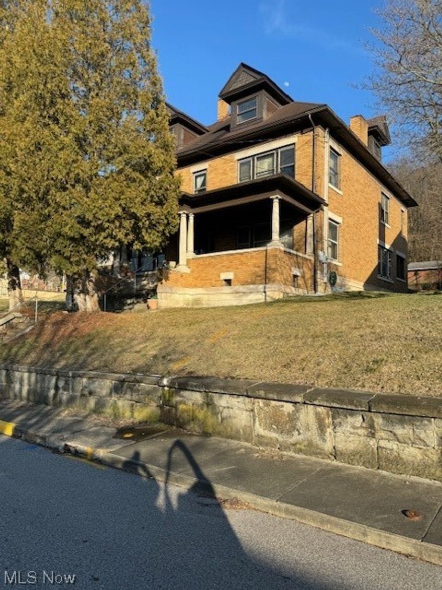Discover this 4,000 sq. ft beauty located in Wellsburg. This Victorian home is nestled in a desirable neighborhood and close to everything in the heart of the town of Wellsburg! It boasts with charm, character and so many nostalgic features. The formal dining room, formal living room, the parlor and sun room are complimented with beautiful hardwood crown molding, coffered ceilings and elegant original hardwood baseboards. The elegant wooden staircases complimenting the entire home. This home also offers 5 nicely sized bedrooms with the original sinks in each bedroom along with recessed medicine cabinets. Home is listed with an additional 2 parcel lot across the street. Perfect for additional outside recreational activities, parking and a beautiful home could be built on this 100x106 corner flat lot. Highlight sheet has latest updates. Whole house vacuum system. Formal parlor and living room have fireplaces to enjoy during the winter blues. Large eat in kitchen also has an alcove complimented with hardwood which offers additional seating. Beautiful front porch with beveled glass front door welcomes all. Relax on the front porch overlooking the hills of Ohio.  Elegant 1912  home is one of a kind. You must see the uniqueness.