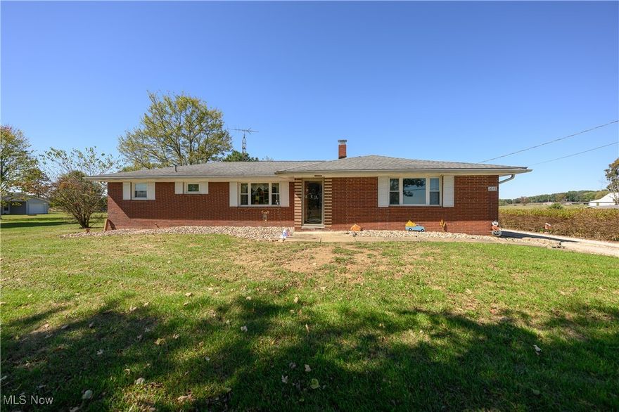 Imagine waking up to breathtaking, expansive views of beautiful farmland from your very own 3 bedroom, 2 bathroom brick ranch home! Situated on a generous 2.169 acre lot, this property offers the tranquility of the country while still being close to Atwood Lake for year-round recreation. The heart of this home is the large family room which perfectly captures those endless, picturesque views, making it an ideal space for relaxing or entertaining. The kitchen has plenty of room to cook the holiday meals and will come equipped with a fridge, stove, and dishwasher. Beautiful hardwoods flow throughout the dining room to carry the charm throughout. The functional floor plan includes three comfortable bedrooms and full bathroom on the main floor. The basement has plenty of space for storage or a man cave. This property is a dream come true for car enthusiasts, hobbyists, or anyone needing extra storage. You get two massive outbuildings - 24 x 32 oversized garage featuring a dedicated workshop area and an additional 24 x 40 garage—plenty of room for boats, RVs, tractors, or all your toys! Move-in ready with significant updates already completed for your peace of mind: windows 2017, furnace 2017, heat pump 2011, water softener 2019, house roof 2013, landscaping, paint, flooring and more! This well-maintained property is ready for its new owner. Don't miss the chance to move in before the holidays and enjoy the stunning views all season long!