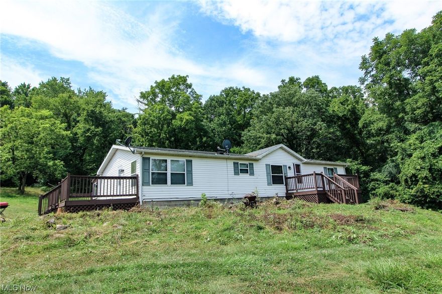 Land and home for sale in Muskingum County, Ohio. If you're looking for seclusion don't miss out on this one! The home is at the end of a 1036+/- foot gated driveway! Make this your permanent home or use it for a weekend getaway or hunting camp with plenty of space for all your outdoor activities. Riding, hiking, hunting, fishing, bird watching or just relaxing on the deck don't let this one get away! Large yard area for your family and pets. 2 older barns for storage. Very scenic and private setting! Any mineral rights owned by the seller to transfer and free gas to the home while it last. Annual taxes are approximately $1216.56.