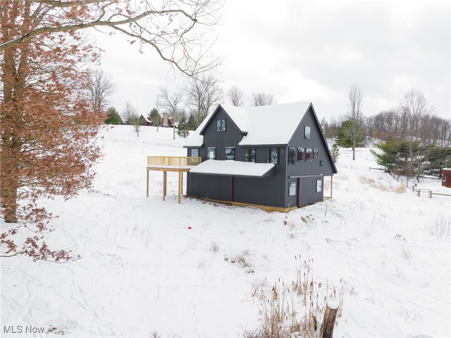 Discover a rare opportunity near Magnolia, OH with this unfinished barn-dominium built in 2022, offering endless potential to create your dream home. Situated on 7.73 picturesque acres, the exterior is mostly complete while the interior awaits your personal touch. The lower level provides ample garage or storage space, the main level features a spacious cathedral-ceiling living area filled with natural light and access to a large wraparound deck, and the upper loft is ideal for additional bedrooms, a game room, or a man cave. The property includes a run-in shed and fencing for livestock, making it perfect for a country homestead, while its proximity to Lake Mohawk, Atwood Lake, and just 35 minutes from Akron-Canton Airport also makes it attractive for short-term rental potential.