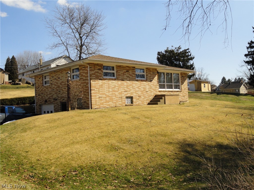 Great brick ranch on nicely landscaped lot. 3 bed 2 1/2 bath with finished, walk out basement and 1 car garage. Spacious rooms, convenient location, covered patio, plenty of yard space. Extra lot with 2 car garage with its own electric service. Many updates including roof, appliances, and HVAC. Extra large family room downstairs, and large living room upstairs makes this home ideal for entertaining.