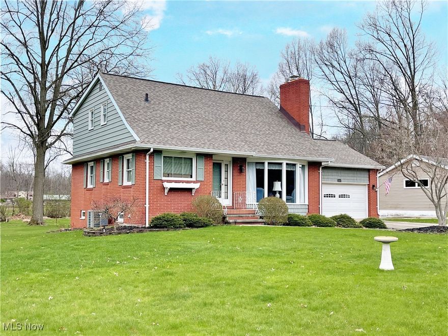 Remember the days of family gatherings when people brought their plates upstairs, downstairs, went out into the yard, had great fun and just spent time together? This house will be perfect for that. Loaded with cherished memories, this custom owner-built Cape Cod has been in the same family for over 60 years. With curb appeal galore, you'll love the brick exterior, accented with shutters and a pretty window box as a finishing touch. The light-filled livingroom features a handsome woodburning fireplace and bay window. You won't mind spending hours in the kitchen loaded with all kinds of cabinets and appliances. Not only will it hold a 6 ft. dining table, there's an extra-long countertop with comfortable seating for four! A great house for multi-generational living, it has two primary bedrooms: a modest bedroom on the main floor with an ensuite bath; and a 16 ft.-wide bedroom upstairs, plus another bedroom, that both share a newly-renovated hall bath with new fixtures and a long countertop with a vanity. You'll find the lower level a dream with a family room and walkout to the rear yard, washer and dryer, a shower and loads of cabinet storage. A patio door on the main level leads out to a covered, sharp two-entrance raised rear deck with composite railings and extra seating, just waiting for the next cookout. If you work on cars, or have a seasonal car you store, there's a second two-plus car working garage with lighting, shop sink, heat and pull down attic storage. It's fantastic! If you favor a strong sense of community, Tallmadge offers so much, including the Tallmadge Rec Center and Maca Park - a 65-acre park featuring the Maca Aquatic Center, with a 6-lane lap pool, slides, shower facilities, ball field, playground, picnic shelters and running and biking trails. You can see it right from the house! Add in the highly-rated public school district with its strong cirriculum and special student and family services, and this one is a sure winner.