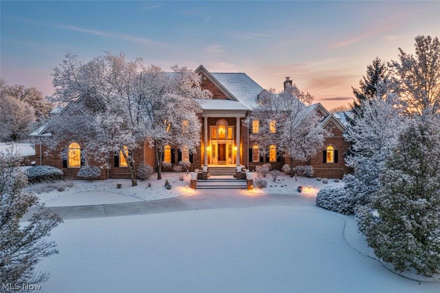 A statement of timeless architecture and refined living, this estate in Richfield’s prestigious Glencairn Forest is a masterwork of scale, proportion, and design. Set on a landscaped acre, the home balances classical presence with contemporary livability and an artful connection to the outdoors. A dramatic two-story foyer introduces the interiors, leading to a great room framed by walls of glass and anchored by a soaring stone fireplace. The chef’s kitchen features custom cabinetry, premium appliances, and a generous island, with a hearth room and adjacent bar designed for effortless entertaining. The main-level primary suite is a private sanctuary with a sitting room and doors opening to the patio. Upstairs, four additional bedrooms and three full baths provide light-filled retreats. The walkout lower level, with new flooring and rough-ins for a bath, kitchen, and gym, awaits final touches to become a premier entertaining space. Outside, architecture extends into the landscape with a stone courtyard, gazebo with two-sided fireplace, full outdoor kitchen, and fire pit—creating a sequence of outdoor rooms that blur the boundary between home and nature. A circular drive and 4-car garage underscore the estate’s presence, while Glencairn Forest’s amenities and the award-winning Revere School District complete this extraordinary offering.