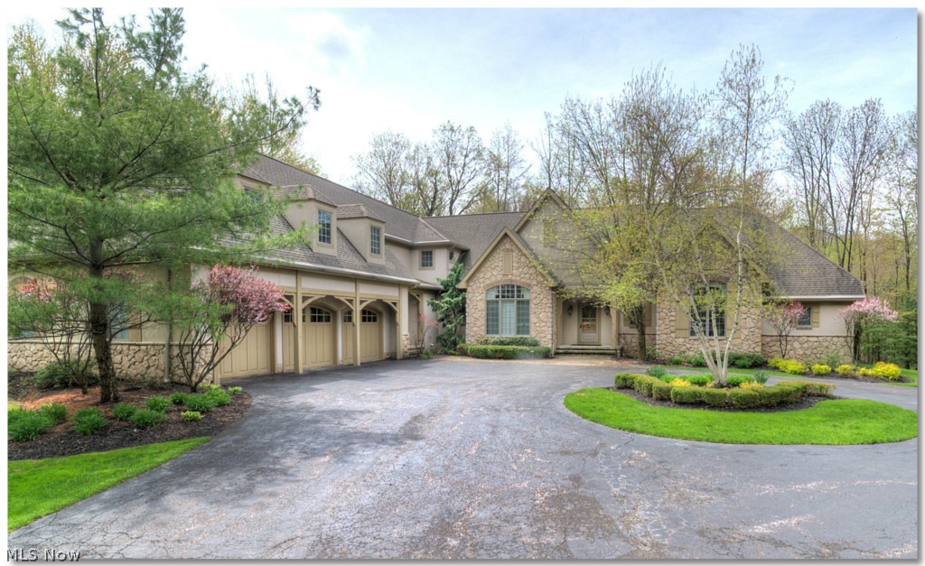 Spectacular French Country inspired custom design/build by Payne & Payne situated on 3 beautifully manicured acres in Russell Township. Attention to detail is front and center in this open flow floor plan. A large entry foyer welcomes you into the main living area w/columned entry to the formal dining room & living room w/vaulted ceiling, exposed trusses & stone fireplace. The kitchen/family room area is the heart of this home, highlighted by extraordinary finishes in the gourmet kitchen, huge family room w/fireplace, large informal dining area and access to the 3 season enclosed porch. A coffered ceiling hallway leads to the library w/exposed trusses and the master suite which offers a large bedroom w/double sided fireplace into the luxurious spa-style bathroom. An iron ballastered staircase off the kitchen leads to a large loft area, off which you find 2 generously sized bedrooms w/walk-in closets and a large bathroom, plus the entry to an additional living suite w/bonus game ro