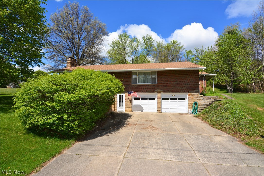 This beautiful raised ranch home in Mogadore sits on just over an acre on a park like setting. This home offers four bedrooms with a finished walk-out lower level. Bonus room can be used as an office or an extra bedroom. The family room and living room both have a beautiful wood burning fireplace. The large kitchen has a built-in wall oven and stove top burner. There's plenty of room for entertaining. Come check it out today. Brick exterior, covered patio and a hi-efficiency furnace. There's plenty of storage space in the attached 2 car garage. The walk up attic allows for even more storage. Call and schedule a viewing today and start packing!
