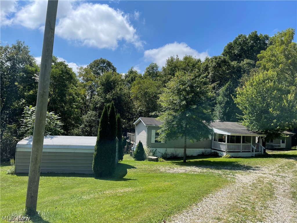 Peaseful retreat, with lots of wildlife to view off your inviting deck. This Manufactured home offers three outbuildings and a carport on over 2 acres. County water and natural gas. Present owner just had the trailer replumbed and new insulation will be installed under trailer prior to closing. Loads of storage in the extra finished shed. Mowed walking trails. Move in ready. Owner must relocate. seller does not own mineral rights. This trailer has been surrendered to real estate.