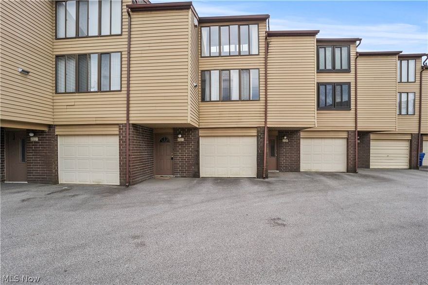 Here is a multi tiered Townhouse Condo located in a quiet community with close proximity to Portage Lakes, shopping, restaurants, and the highway. The lowest level has the foyer entrance, a laundry/utility area, a separate entrance from the single car garage and an open staircase to the main level. On this main level the floor plan is open and encompasses a large living room/ dining room combo, a galley kitchen and sliders to the deck porch. This condo is rustic and charming with exposed brick walls, large windows bringing natural light and an expansive wood beamed ceiling. There is a metal spiral staircase to the third level that includes the  spacious loft bedroom and full bathroom. 
The foundation of this condo has shifted slightly creating some unevenness that can be detected when walking on the main floor. Structural report available in the supplements. This is a great opportunity to own a reasonably priced condo in a well maintained community.