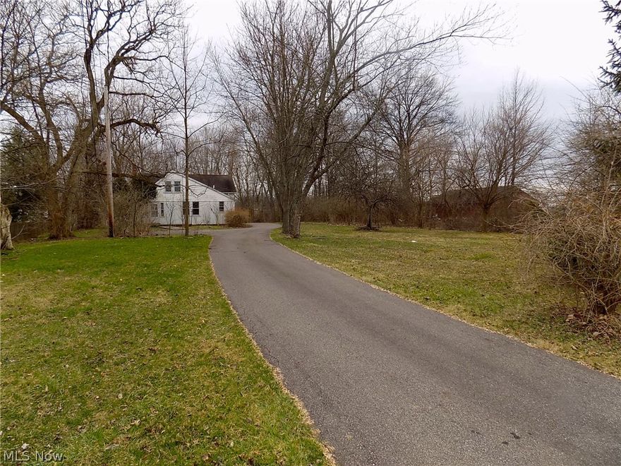 Home Sweet Home(s)!!!  This property has charm, character and a serene country feel & setting.  Over 1.25 acre wooded lot with lots of green space located in Olmsted Township.  The main home features open concept living with a large renovated kitchen with island & first floor laundry.  The cottage/in-law suite is spacious and private from the main home.  2-car garage features a large workshop and lots of overhead storage.  Main house has public water & sewer and the back house/cottage has public water and septic plus there is a well - perfect for watering the property.  Same loving owner for over 40 years - home being sold as-is.