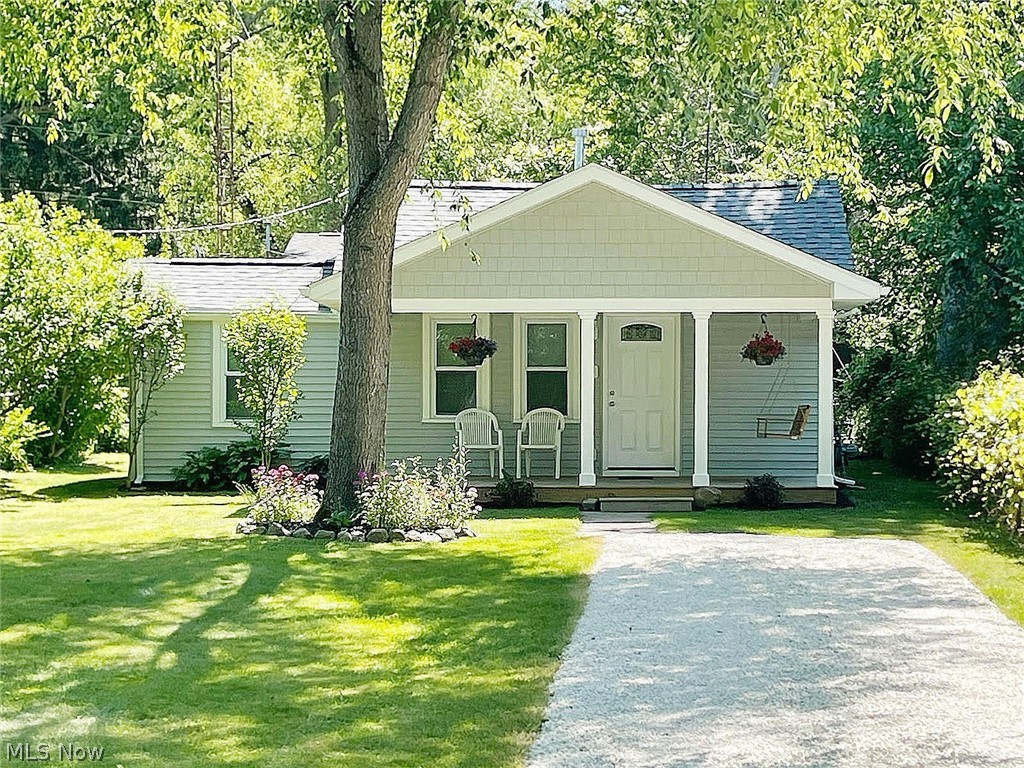 Put your money to work for you in this expertly-remodeled, 2-bedroom Munroe Falls ranch where you won't have to lift a finger! You'll love the super sharp living areas, which include newer windows, doors, flooring and paint. The kitchen appliances will make cooking easy. There's even a brand new over-the-range microwave and a dining room nearby. You'll appreciate the HVAC system, the electrical updates, the vinyl windows, the water heater is newer and there's even a stackable washer and dryer for added convenience. If you're just starting out, are downsizing or are looking for an alternative to dorm, apartment or condo living, the house will be perfect. You're within 15 minutes of both KSU and the University of Akron, and highway access to Cleveland and Canton isn't far away. When it comes to favorite covered front porches, this one will probably end up on the top of your list. 19-ft. long and as pretty as can be, you'll be able to step out at the end of a hard day and sit for hours, relaxing with friends or family. The front porch swing even comes with the house! For hosting larger events, you're within walking distance to Galt Park, a wonderful neighborhood park featuring a playground, picnic tables and a lodge you can rent, with a stone fireplace and kitchen. Make plans to see this one today. You won't want to let it pass you by!