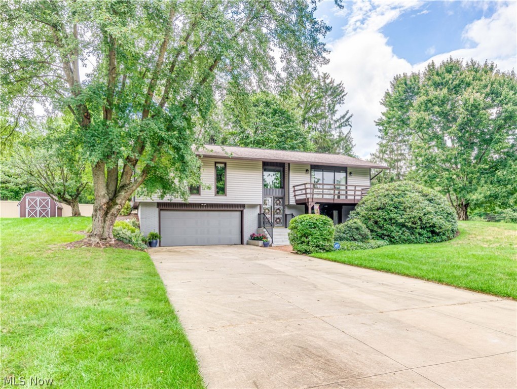 Meticulously kept since 1972, this one owner beauty is situated on a picturesque one-acre treed lot. As soon as you walk in the front door you become aware that the oversized windows and sliding doors allow the entire home to be drenched in natural sunlight. The sizable formal living room offers sliders to the front deck and the dining room sliders lead to the screened-in back porch. A spacious eat-in kitchen includes a convenient breakfast bar, all appliances and leads to the back porch. The master bedroom boasts an ensuite bath. Another full bath and two other well sized bedrooms complete the main level. The lower level boasts a huge family room with a gas fireplace and sliding doors that lead to a brick patio. A half bath, storage area and laundry room complete the lower level. Entry to the two-car garage is in the lower level. As perfect as the inside is, the exterior has much to offer. A 28x16 screened in porch comes complete with a hot tub and includes custom blinds. The por