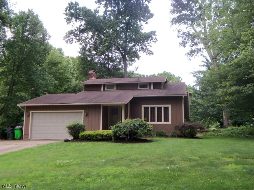 Attractive Contemporary, 2 story foyer, large living 13 x 23 with vaulted ceiling. 3 generous bedrooms, master bedroom suite with balcony to back yard, formal dining with built-in storage, first floor family room with cozy wood burning fireplace, large deck across the back of entire house, partially finished basement with extra entrance from the garage, oversized 2 car garage. Many updates: Kitchen, 2 1/2 new baths, new carpet throughout, freshly painted in and out. Ready to move in. Quiet area of Green near Nimisila Reservoir Park.