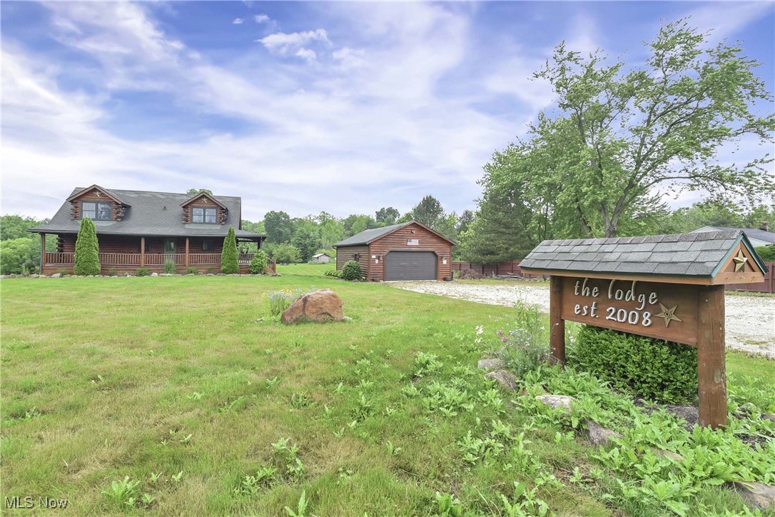 Do you desire a simpler way of living, a retreat from every day life stressors? Connect with nature in this sweet log cabin home on nearly 3 acres of serene property. The Lodge was quality constructed in 2008 by REAL LOG HOMES with a wraparound porch, detached oversized garage, 4 bedrooms, second floor primary suite and loft, 3 full baths and a walk-out lower level. Enter into a gorgeous great room, flooded with natural light, hardwood flooring, exposed beams, vaulted ceiling and sweeping views of blue skies, a slightly rolling landscape and mature trees. Well equipped kitchen with plenty of storage, Knotty Alder cabinets, granite counters, double bowl stainless sink, center island with live edge wood top and black appliances. First floor laundry and two first floor bedrooms, one used as a home office, plus a full bath with tub/shower combination, wood vanity and framed mirror. Imagine the peace and tranquility you will find cozied up in the loft, captivated by incredible views. Master retreat features angled beams, creative storage and en-suite with skylight, soaker tub, standalone shower and dual vanity. Lower level rec room adds the perfect man cave or additional living and entertaining space. Fourth bed, full bath, utility / storage room and additional storage room with plumb for a utility sink or future wet bar. Fifty year log, stained in 2019, central vac, geothermal heat, hookup for generator, cistern (public water available at the street) and septic. Detached garage (35 x 24) constructed of faux logs, offers 220V 50A breaker, heater (propane), water, tons of cabinets and storage, perfect for the car enthusiast or tinkerer. Although you may never want to leave this slice of Heaven, The Lodge is located conveniently off 224 with easy access to highway and minutes from Black River Nature Preserve and Lodi Community Park.