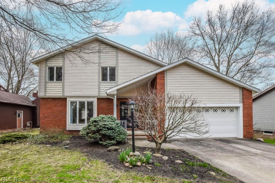 Beautifully remodeled 3 bedroom, 2.5 bath colonial with a finished lower level! This move-in ready home boasts a newer roof, gutter guards, gutters, downspouts, furnace, A/C and hot water tank in 2021 plus a modern kitchen and updated bathrooms! The foyer entry with built-in coat rack has sight lines into the living room as well as into the stunning kitchen with white cabinetry, quartz countertops, stainless steel appliances, tile backsplash, a pantry and a breakfast bar! There's also a dining room for larger gatherings. The adjacent great room with vaulted ceilings and deck access offers the perfect spot to unwind. A convenient half bath rounds out the 1st floor . Upstairs, the master suite offers a walk-in closet and a private full bath with a tiled walk-in shower. There are 2 additional bedrooms and a full bath with tile shower surround and twin vanities set against a shiplap wall. The full basement adds extra living space with a finished rec room as well as fantastic storage on the utility side. Wonderful turn key home nestled on a park-like lot, close to all amenities!  Call to schedule your showing today.