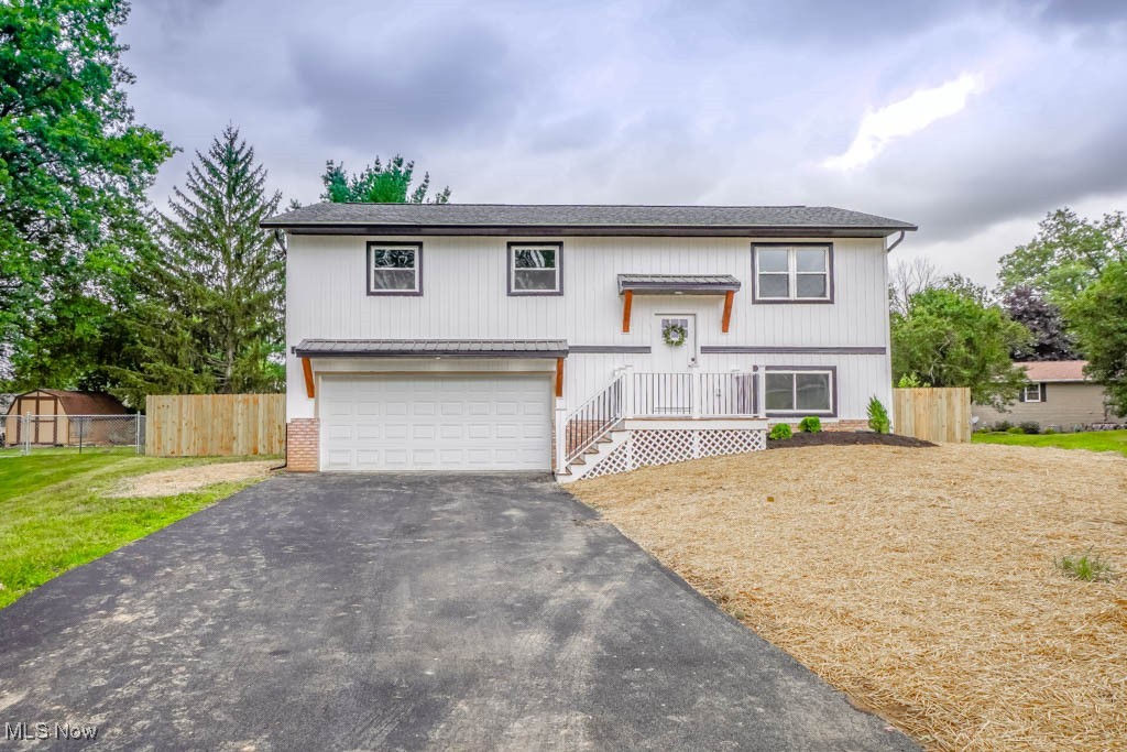 You'll feel right at home in this beautifully remodeled bi-level in Northwest Schools! The main level features an open layout that connects the living room and eat-in kitchen with new LVP flooring throughout. The kitchen includes stainless steel appliances, new countertops, a tile backsplash, and a center island with counter seating. Down the hall, all three bedrooms offer fresh carpet and nice-sized closets, along with a brand new full bath with a tiled tub and shower surround. The finished lower level adds extra living space with a light-filled rec room that opens to the patio and fully fenced backyard. There's also a second full bath and access to the two car garage with a new opener. Updates include new windows, siding, gutters, interior and exterior doors, and lighting. Tucked on a cul de sac in an established neighborhood with easy access to everything you need. Call today to schedule your tour!